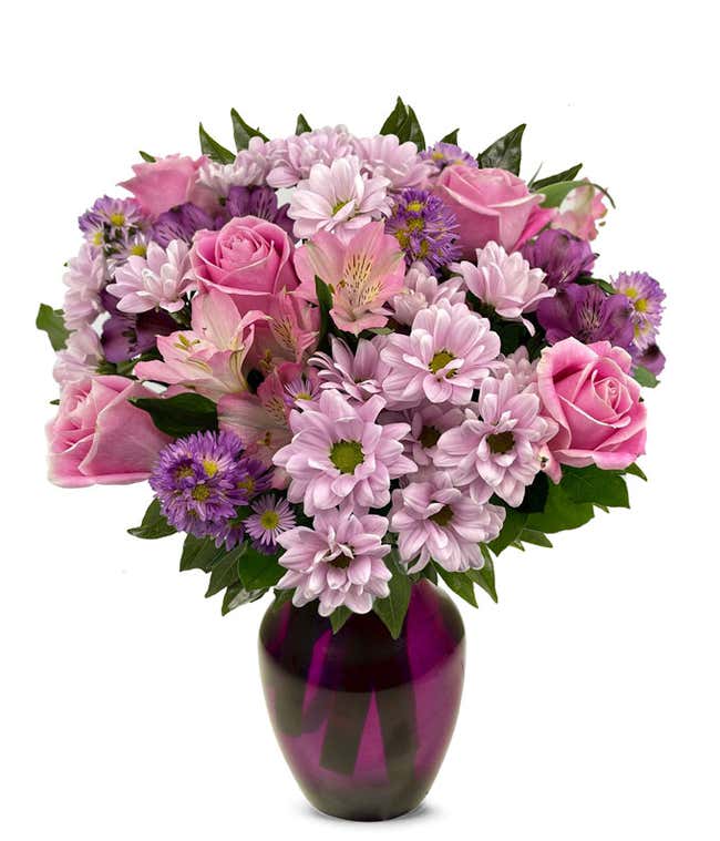 A vibrant arrangement featuring pink roses, purple daisies, pink alstroemeria, purple alstroemeria, and purple Monte Casino, optionally arranged in a vase. This colorful mix offers a cheerful and lively display.