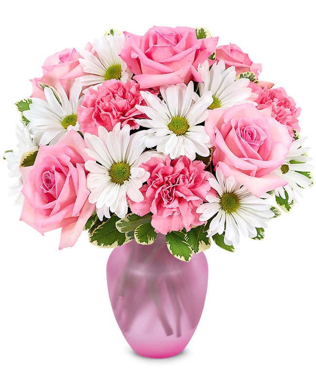 Floral arrangement featuring pink roses, white daisies, and pink carnations, optionally in a vase.