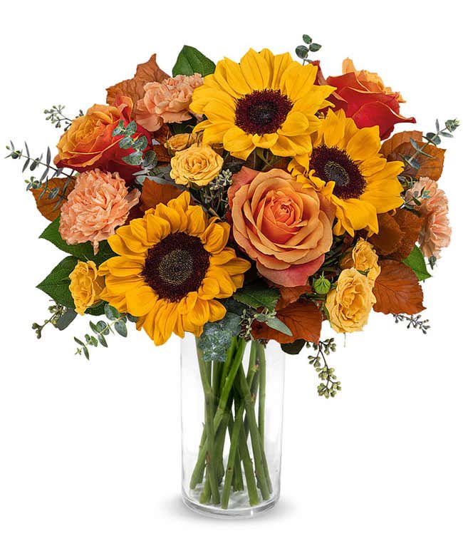 Orange and yellow roses, peach carnations, yellow sunflowers, brown copper beech, seeded &amp; spiral eucalyptus, 