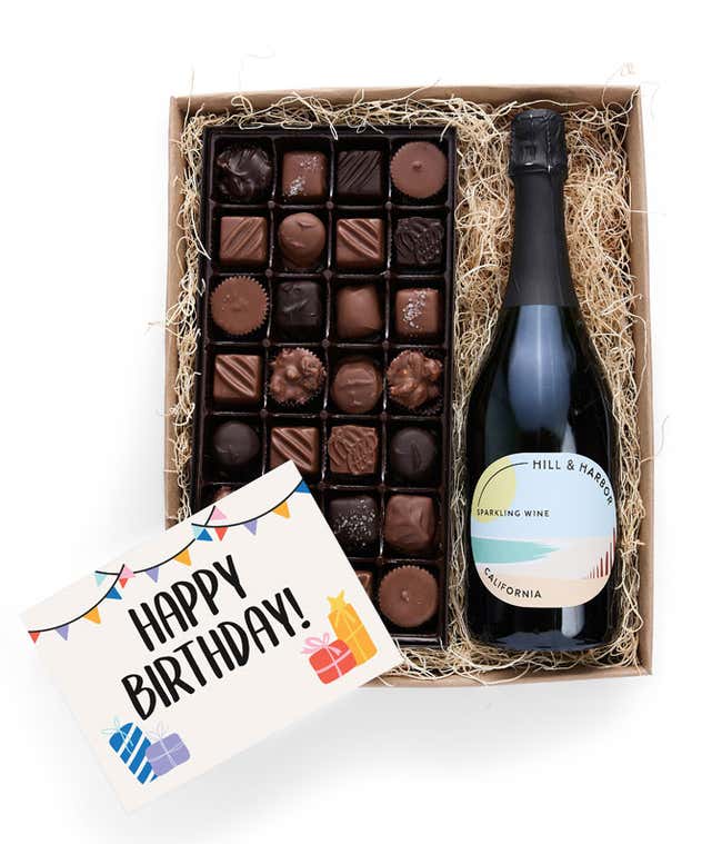 A birthday gift box containing a bottle of Hill &amp; Harbor Sparkling Wine, a 1 lb box of 28 assorted gourmet chocolates in a grid, and a birthday message card.   A refined combination perfect for birthday celebrations.