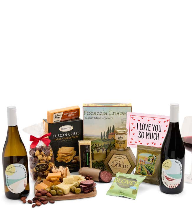 A luxurious gift box with a bottle of Hill &amp; Harbor Pinot Noir, three cheeses, gourmet crackers, summer sausage, marinated olives, smoked almonds, stone-ground mustard, chocolate-covered, and a pink 'I Love You So Much' card